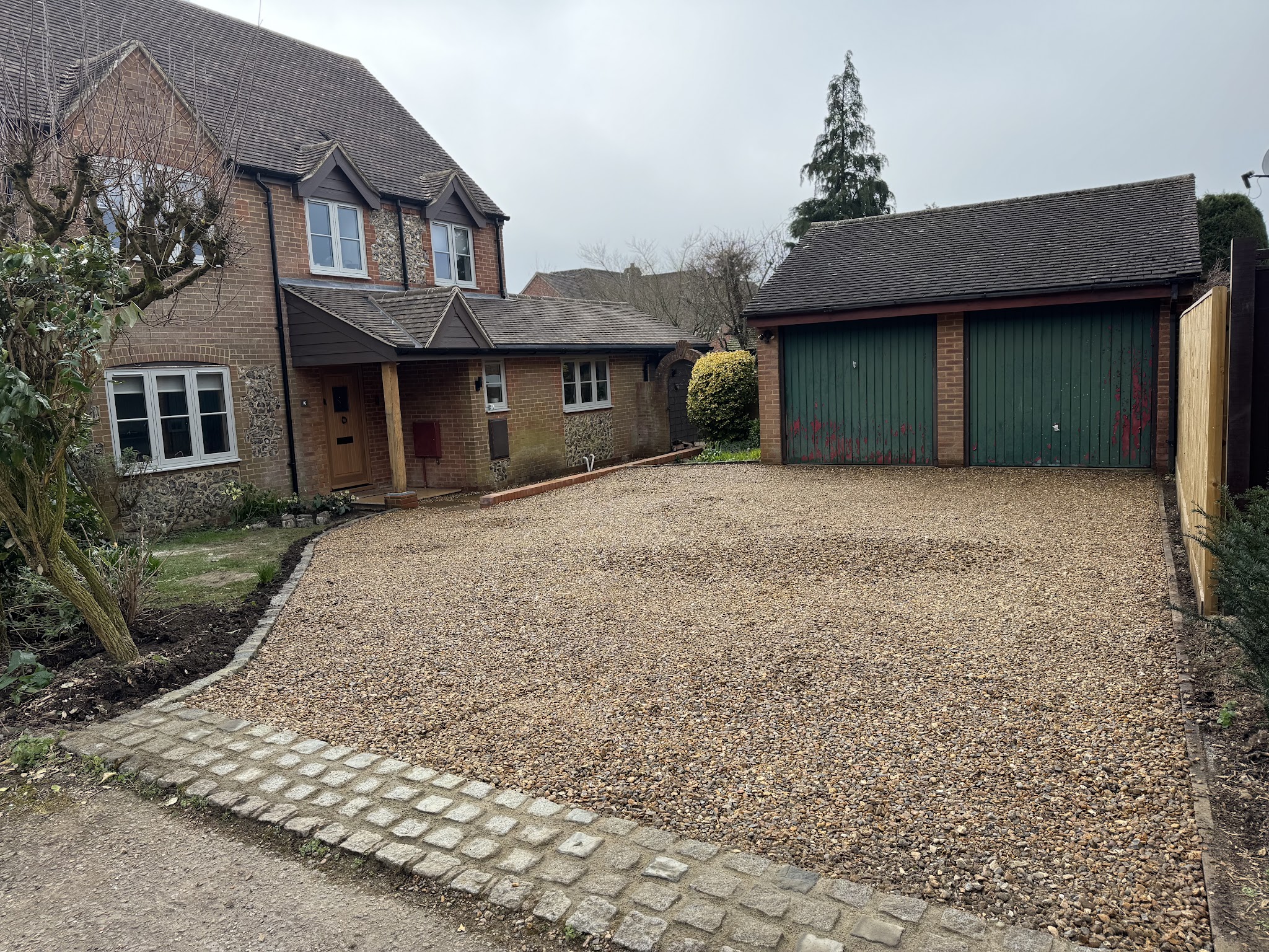 The same house with a finished gravel drive and granite sett edging