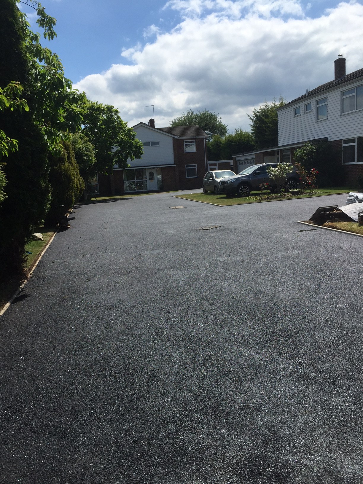 A new tarmac surface on a shared close between houses