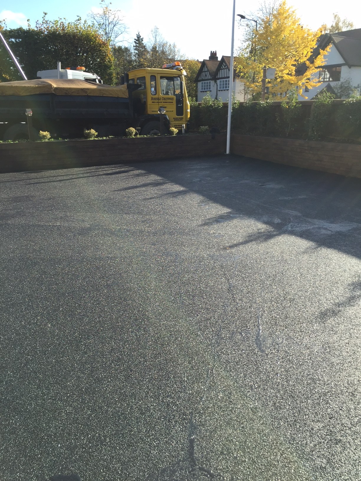 A wide new tarmac forecourt with a Roefield lorry by the hedge